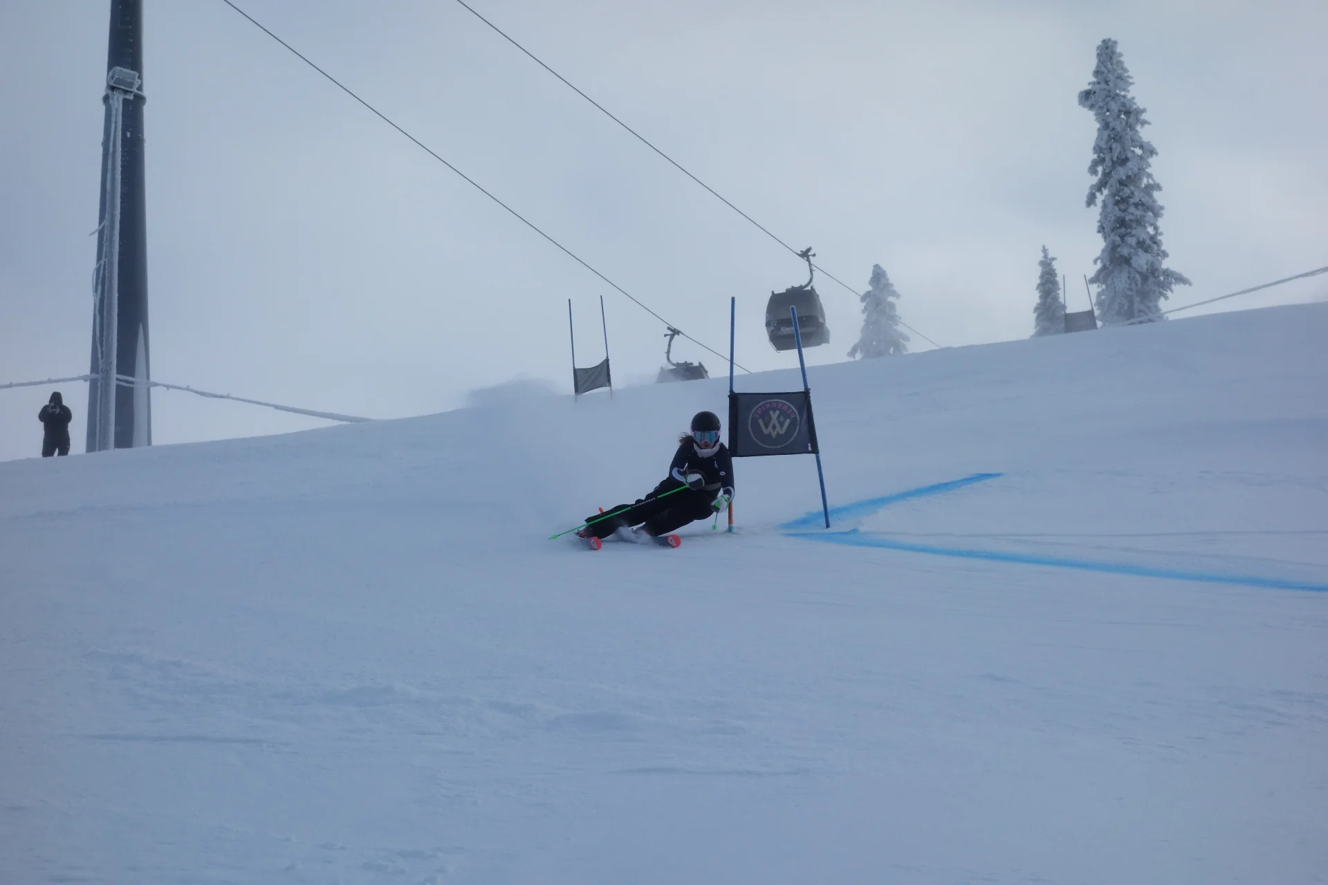 Peregrine female alpine ski racer carving a turn at sunrise